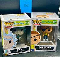 Front view of Rick #112 and Evil Morty #141 boxed figures in protectors