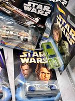 Assortment of sealed Hot Wheels Star Wars character cars and starships on cards
