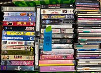 Overview of box with VHS tapes on left/middle and stack of audio cassettes on right