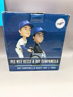 Front of original display box showing graphic of bobblehead and event text
