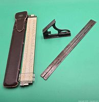 Slide rule in sheath, try square head and steel rule overview