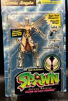 Front view of sealed Cosmic Angela figure, accessories visible