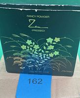 Outer cardboard box front showing Zen Fancy Powder label and weight