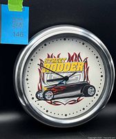 Front view of Street Rodder wall clock showing dial graphic and bezel