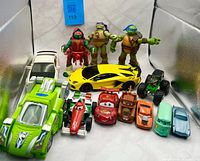 Group shot showing all three TMNT figures and ten vehicles