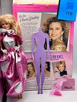 Christie Brinkley doll in gown beside back of original box, accessories visible