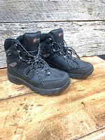 Side view of both boots showing overall condition, rubber shell, uppers, and laces