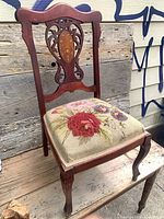 Full view of mahogany side chair on wooden surface