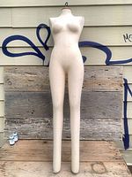 Full frontal view of linen-covered female dress form mannequin