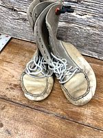 Full view of both boots standing upright showing uppers, laces and toe stitching
