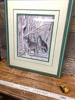 Full view of framed painting with tape measure for scale