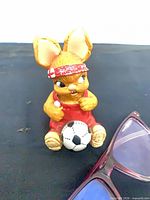 Front view of PenDelfin rabbit figurine holding soccer ball