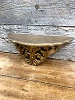 Front view of resin acanthus wall shelf