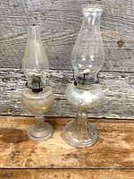 Two glass kerosene lamps side by side