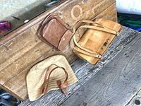 Overview of three handbags on wooden surface