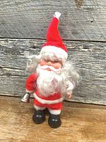 Front view of vintage mechanical Santa figure showing suit, beard, bell, boots