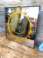 Front view of square mirror showing full sunburst design