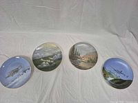 Four aviation collector plates displayed face up