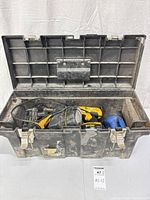 Open toolbox with DeWalt drills, batteries, charger visible