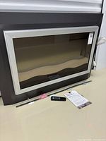 Front view of Dimplex electric fireplace with accessories visible