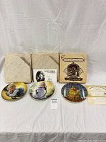 Three plates with boxes and certificates displayed