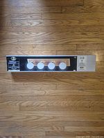 Front view of boxed Hampton Bay 4-light vanity fixture showing product image and branding
