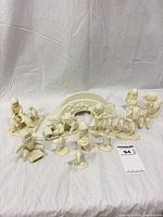 Group shot of all 11 ivory resin/chalkware winter figurines