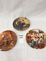 Front view of all three plates showing Rockwell scenes