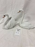 Both Lladró swan figurines side by side