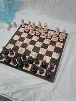 Full chess set on board showing both color piece sets