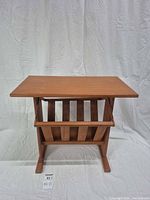 Front view showing top, slatted magazine rack and base