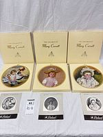 Three Mary Cassatt series plates in boxes with pamphlets visible