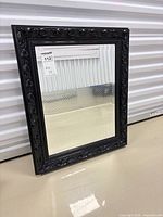 Front view showing full ornate framed mirror