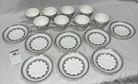 Front view of all eight cups and eight saucers laid out