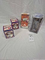 Full lot view showing two boxed baseballs, VHS and bobblehead