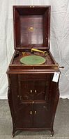 Full view of open Victrola console showing cabinet, turntable and tonearm