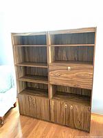 Front full view of bookcase showing shelves, desk compartment, and lower cabinets