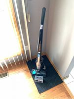 Full view of Electrolux Ergorapido stick vacuum on charging base