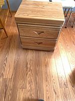 Front view showing full nightstand, both drawers, wood grain, handles