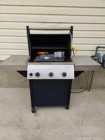Front view of Vermont Castings gas grill closed, showing casters and control panel