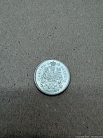 Reverse of 1963 Canada 50-cent coin showing Coat of Arms and denomination
