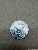 Reverse with eagle landing on the moon, UNITED STATES OF AMERICA ONE DOLLAR legends