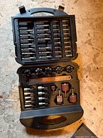 Full view of open case showing driver bits, drill bits, sanding drums, sockets