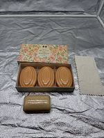 Open Bronnley floral box displaying three oval soaps in tray and separate Witch Hazel bar with included cloth
