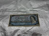 Obverse of 1954 $5 note showing portrait, denomination, serial number
