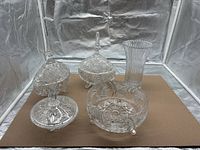 Full group shot of two covered dishes, footed bowl and vase