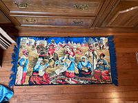 Full view of rectangular cotton rug/tapestry with figural scene and blue fringe