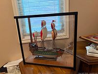 Front view of model ship within display case