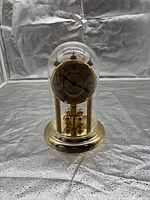 Full view of Hettich anniversary clock under glass dome