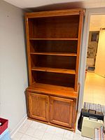 front view of full bookshelf showing shelves and lower cabinet